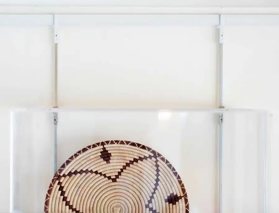 Not all artwork hangs in a frame, here you see an Acrylic Display Case for hanging woven baskets and keeping them secure.